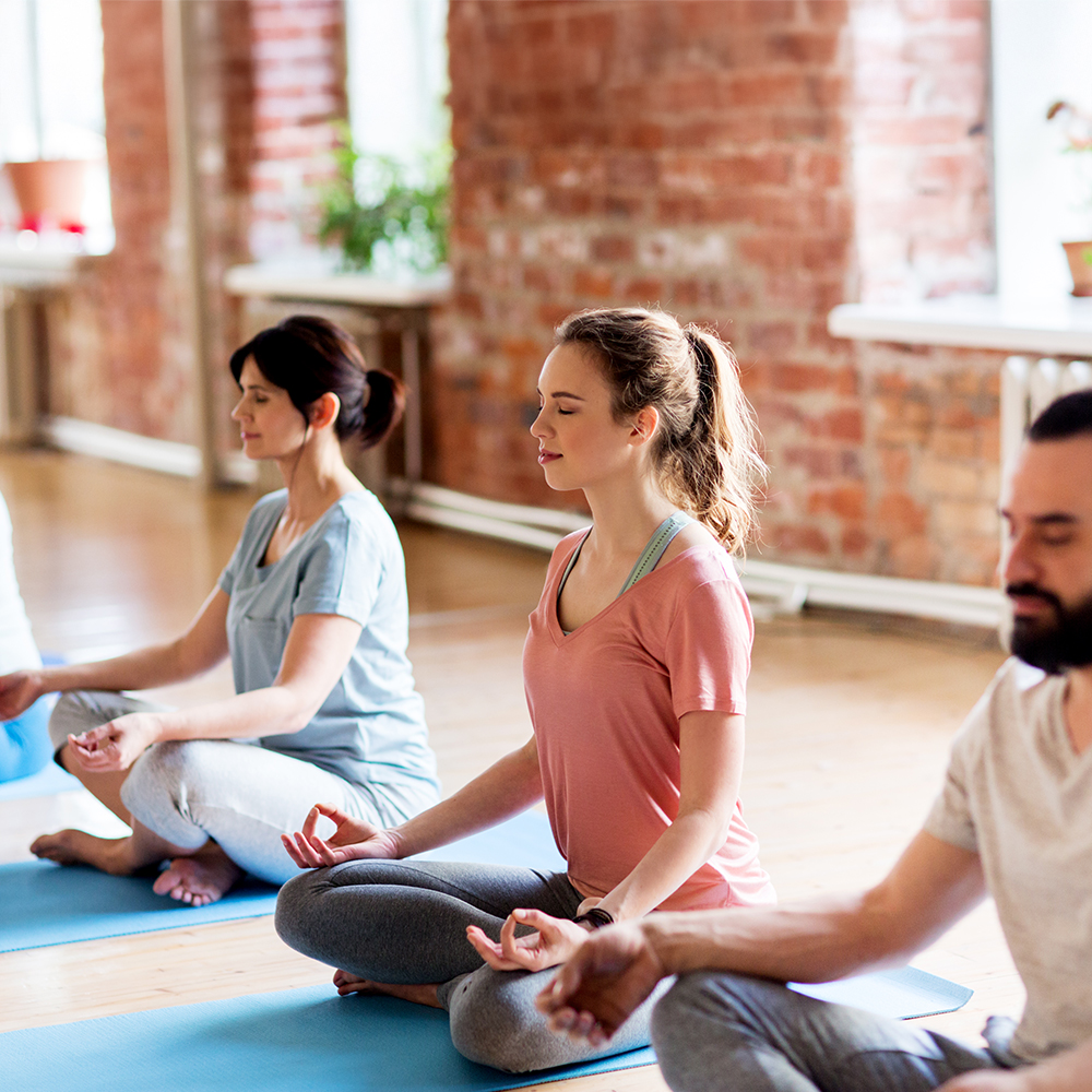 group-of-people-making-yoga-exercises-at-studio